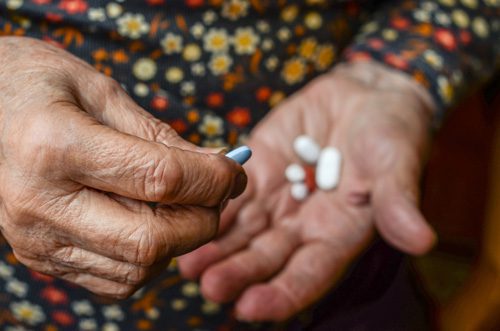 Senior Citizens and Addiction - elderly woman with pills
