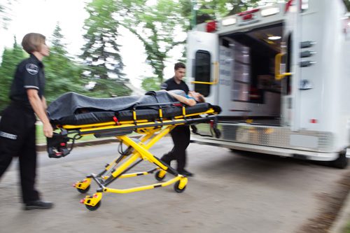 The Most Common Causes of an Overdose - paramedics loading young lady into ambulance