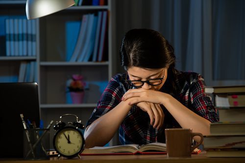 female college student up late studying - stressed out - study drugs