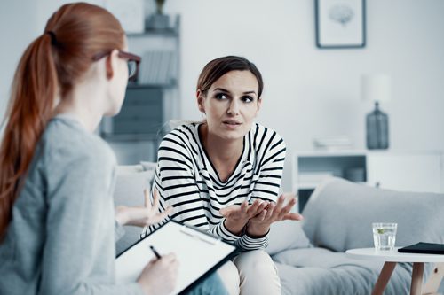 young woman in therapy session - cognitive behavioral therapy