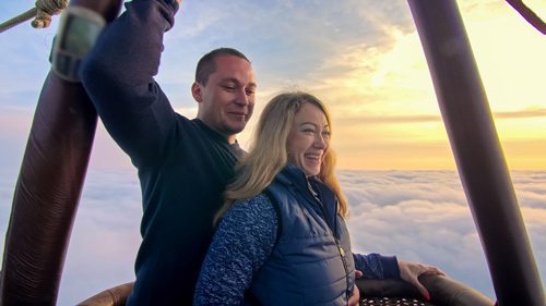 man and woman on Valentine's Day date in hot air balloon