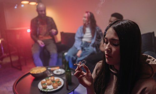 group of teens smoking drinking triggers relapse